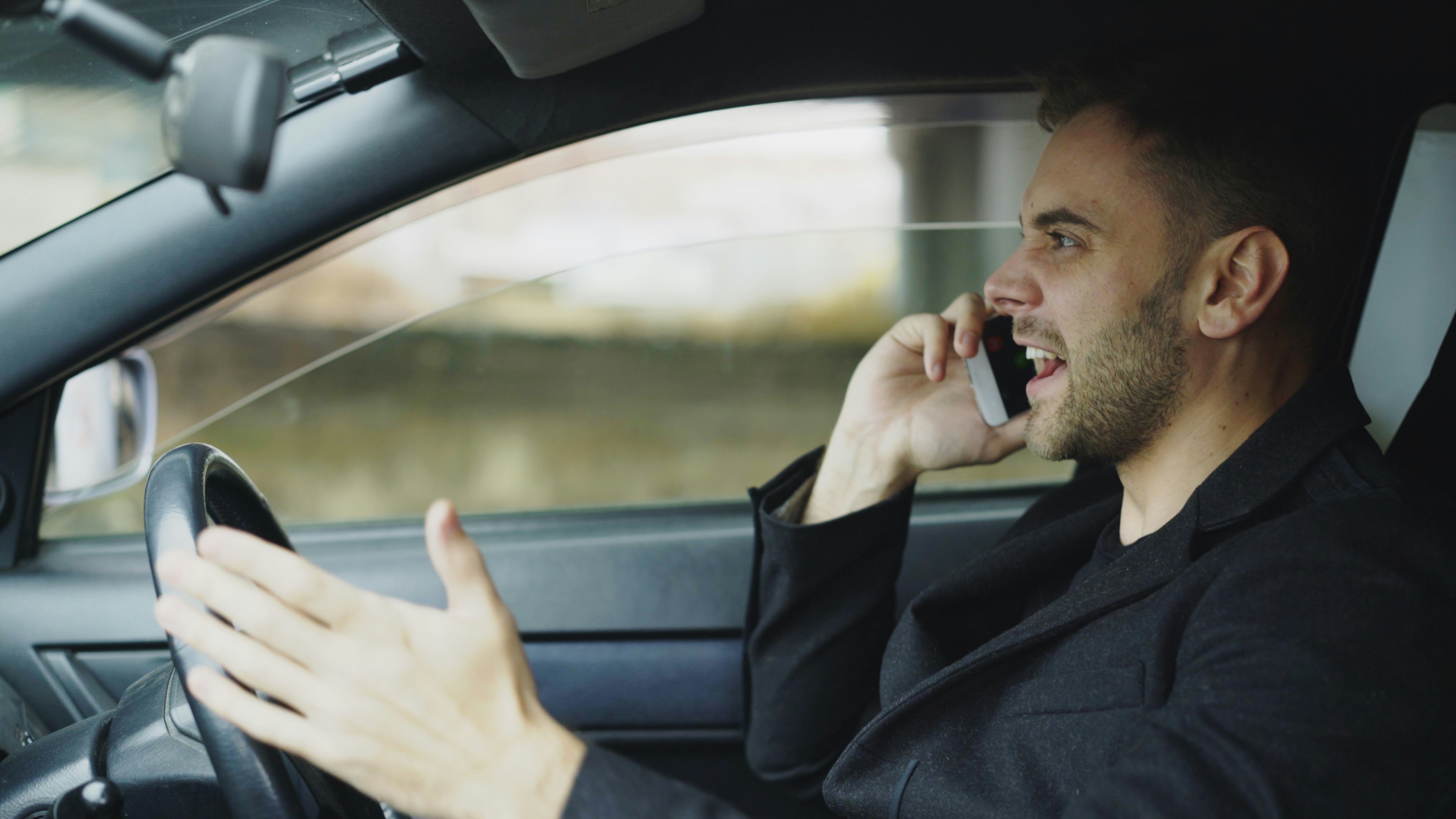 A commuter using his phone on the drive home from work, the core use case BrewDock is designed for