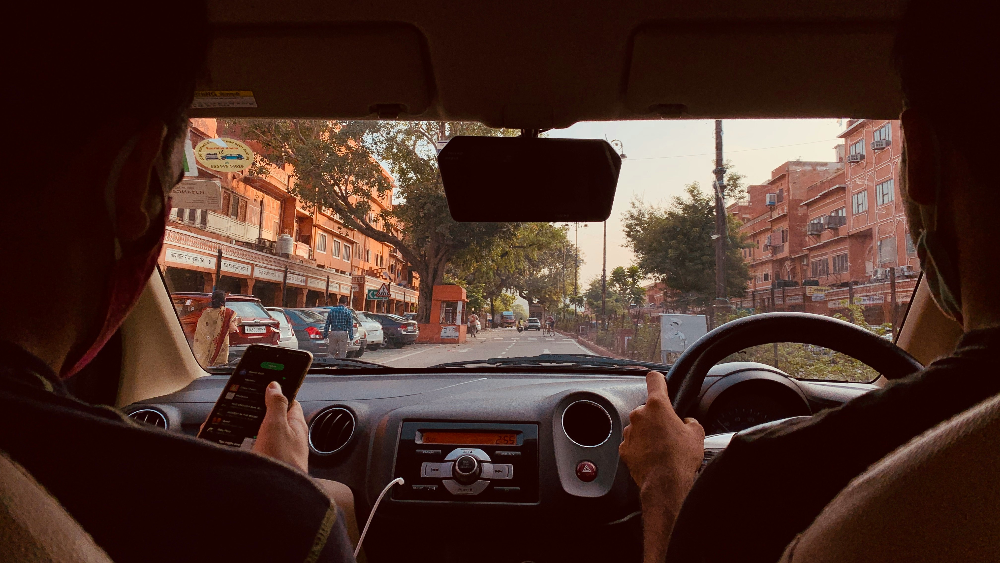 The view through a car windshield on a morning commute — the daily scenario BrewDock is built around